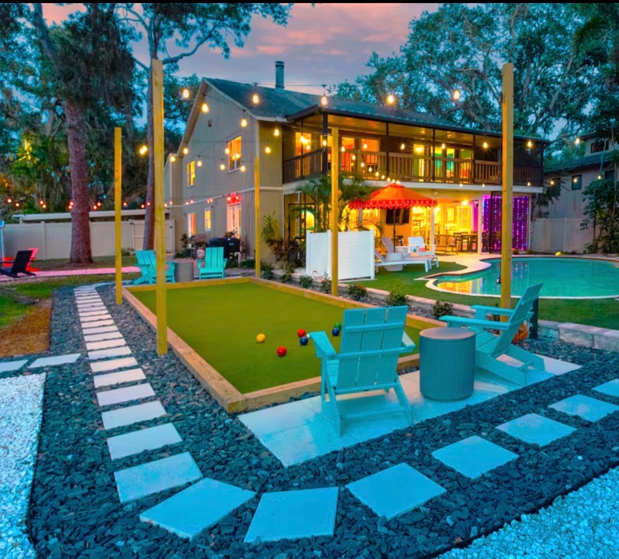 Paver patio and pool surround beside a bocce court